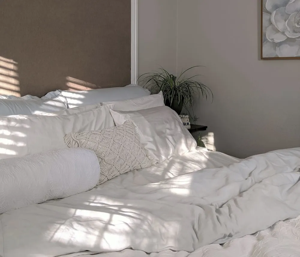 Crisp, freshly made bed in a tidied bedroom in Watertown, MA