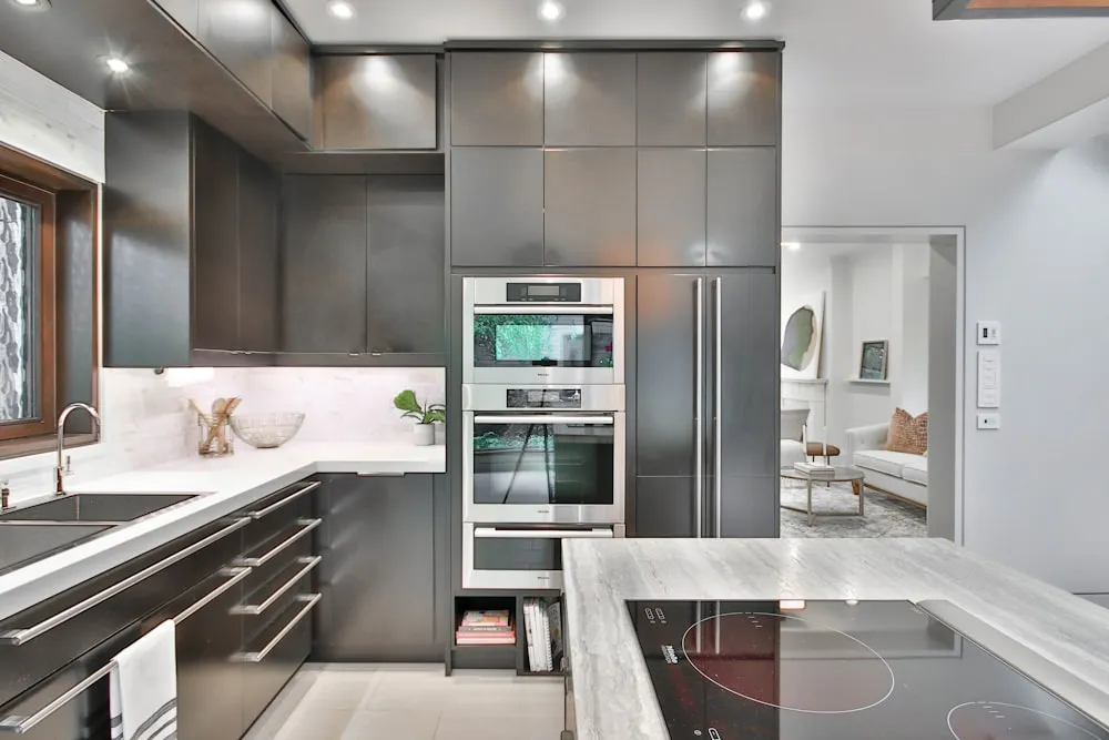 Modern kitchen with polished stainless steel appliances after detailed cleaning in Somerville, MA